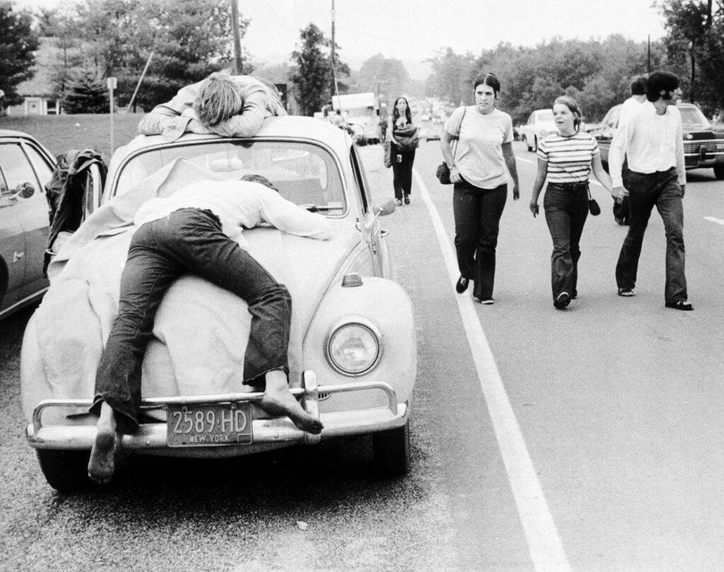 Two festival goers who found Woodstock too much lie passed out on the hood and roof of a Volkswagen Beetle in August 1969. Three Lions/Getty Images