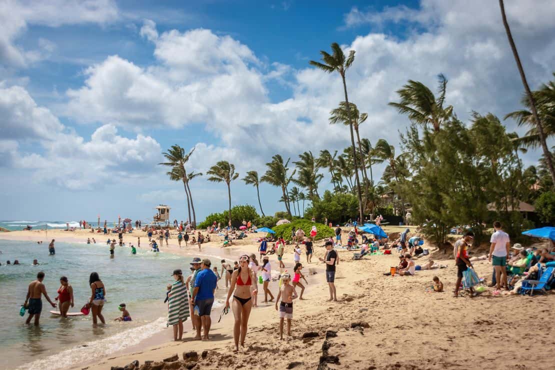 People enjoy Poipu Beach on the island of Kauai on April 7, 2024.